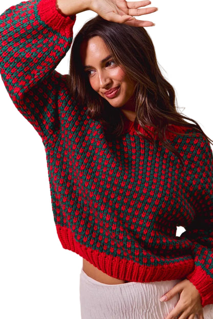 Woman wearing a red and green patterned sweater against a beige background