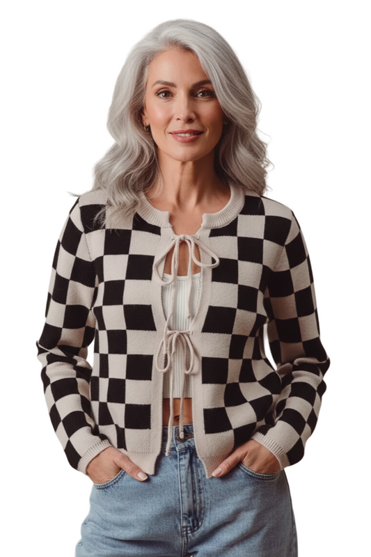 Woman wearing a black and white checkered cardigan with a beige background