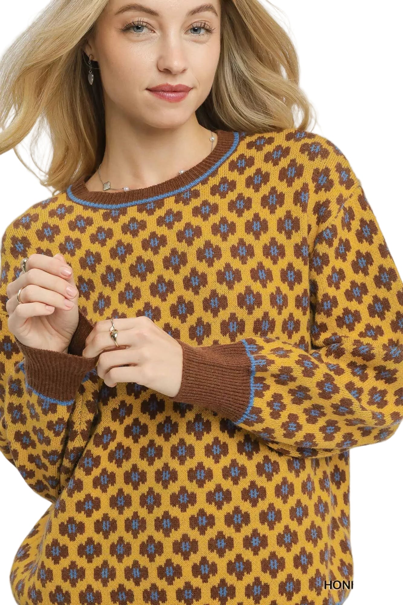 Woman wearing a patterned sweater with a white background