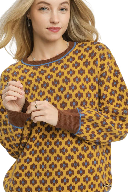 Woman wearing a patterned sweater with a white background